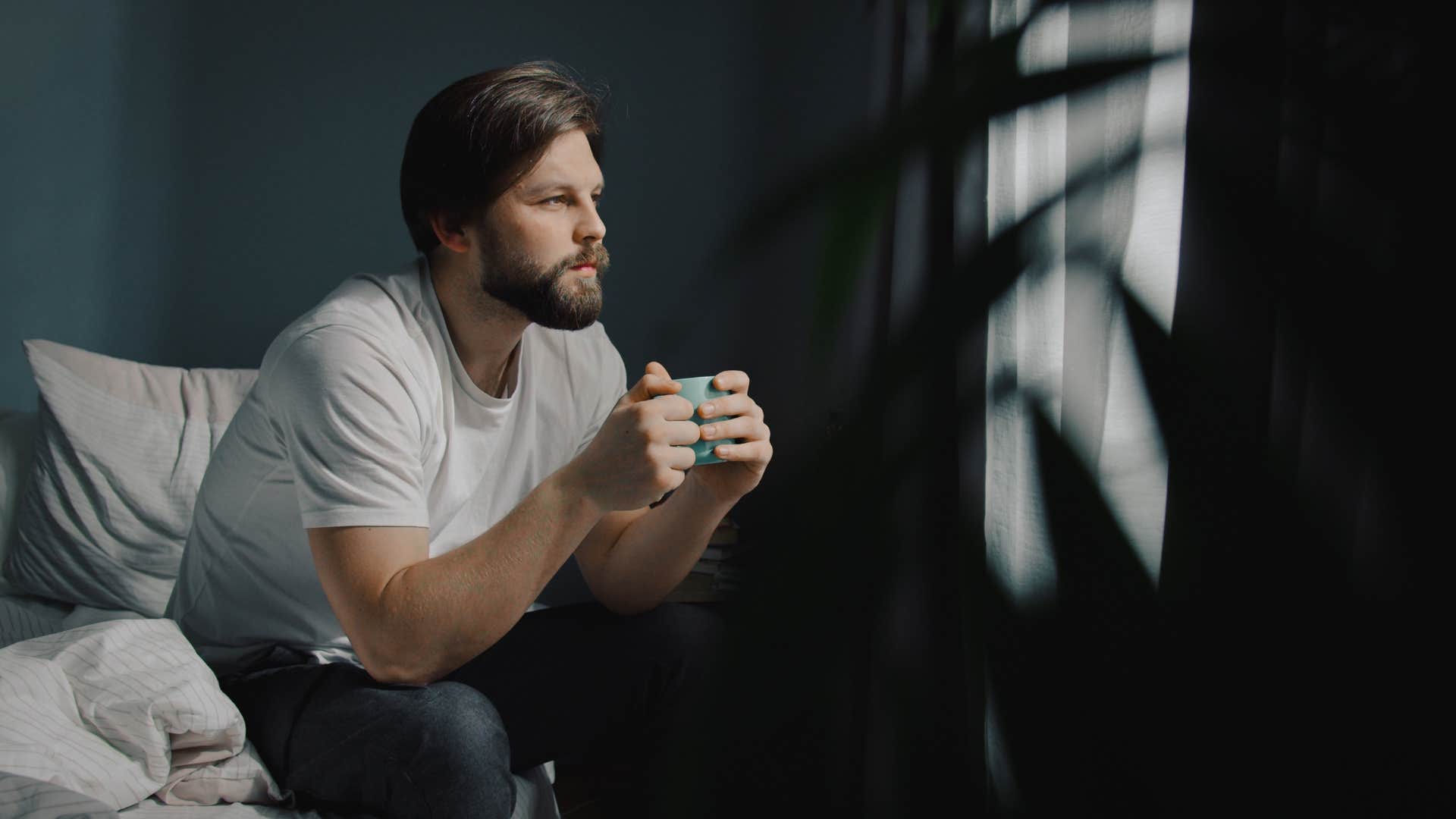 attractive man over 40 feeling comfortable with alone time relaxing at home
