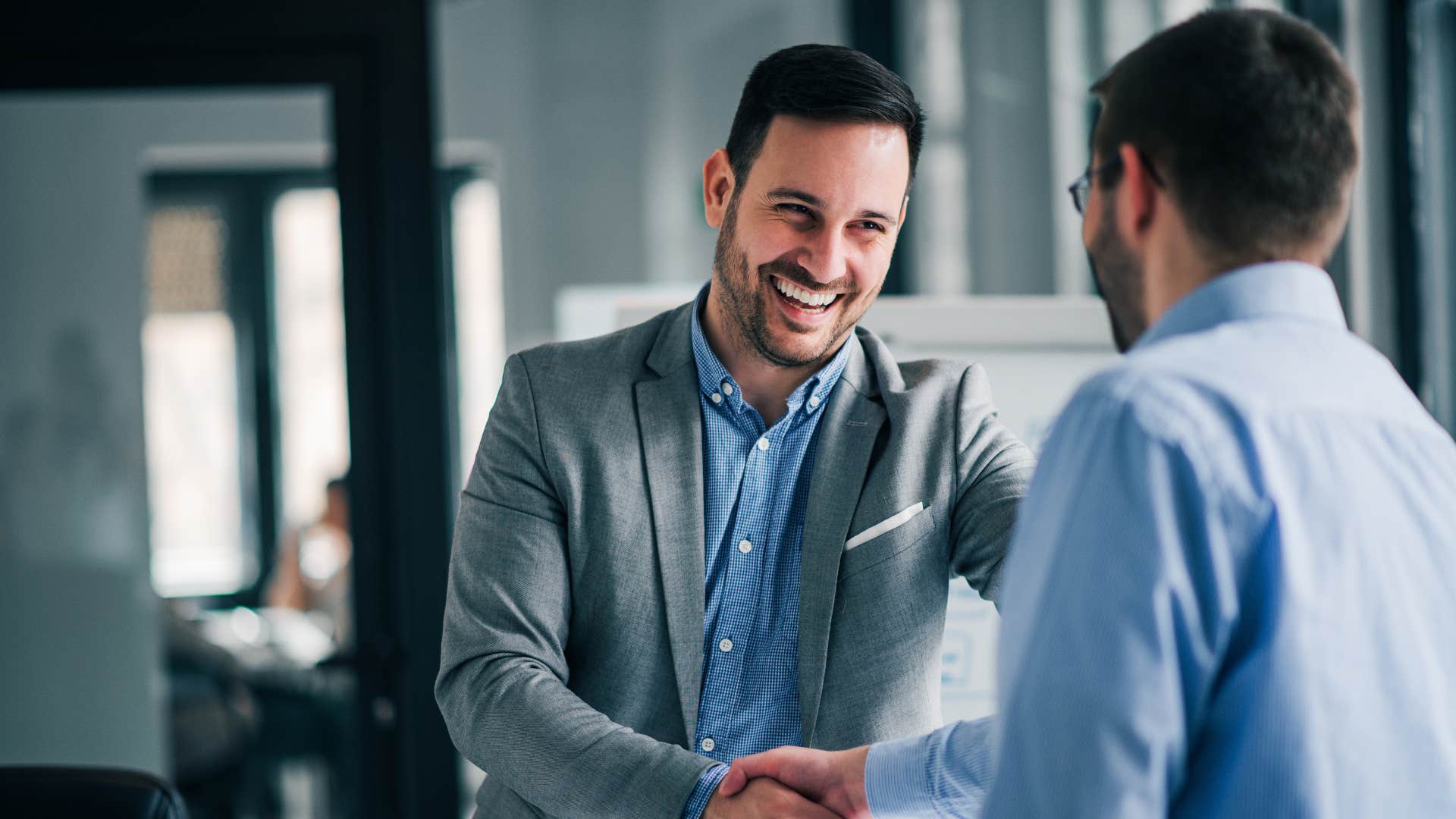 man shaking hands with colleague showing respect