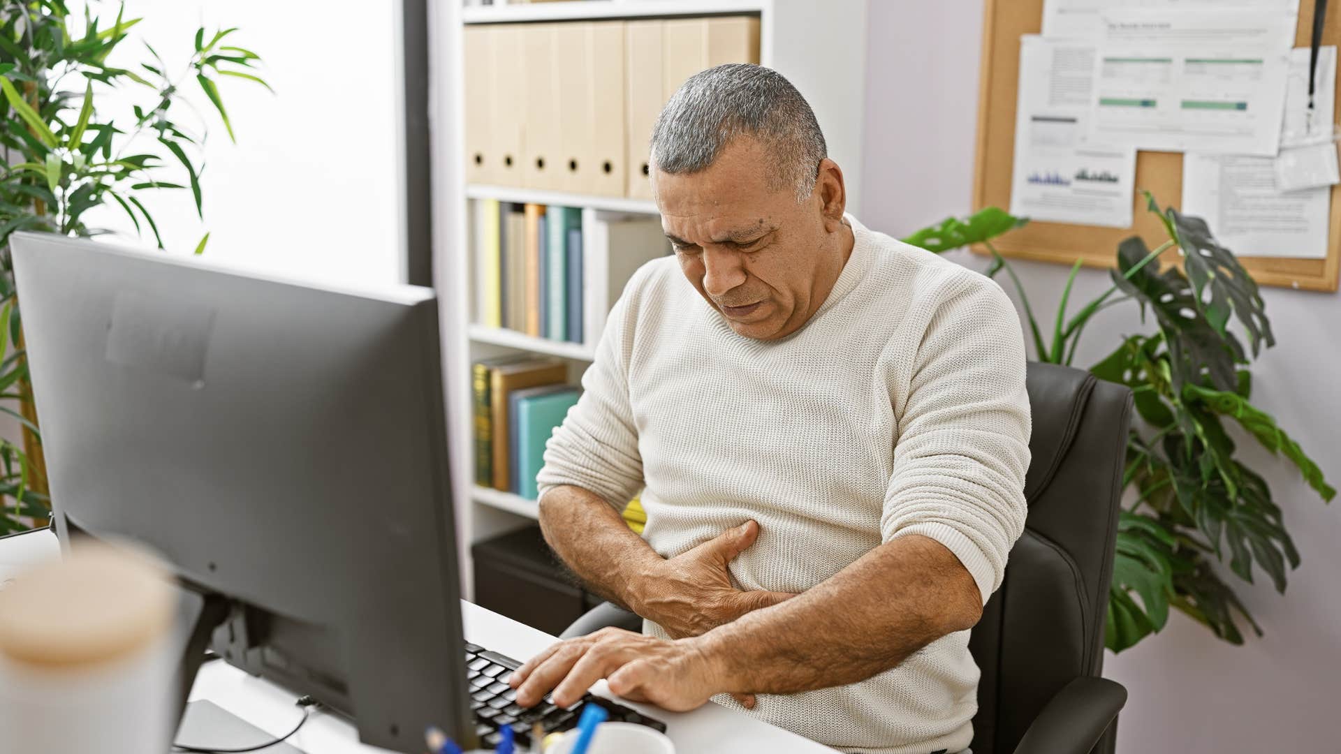 older person touches uneasy stomach