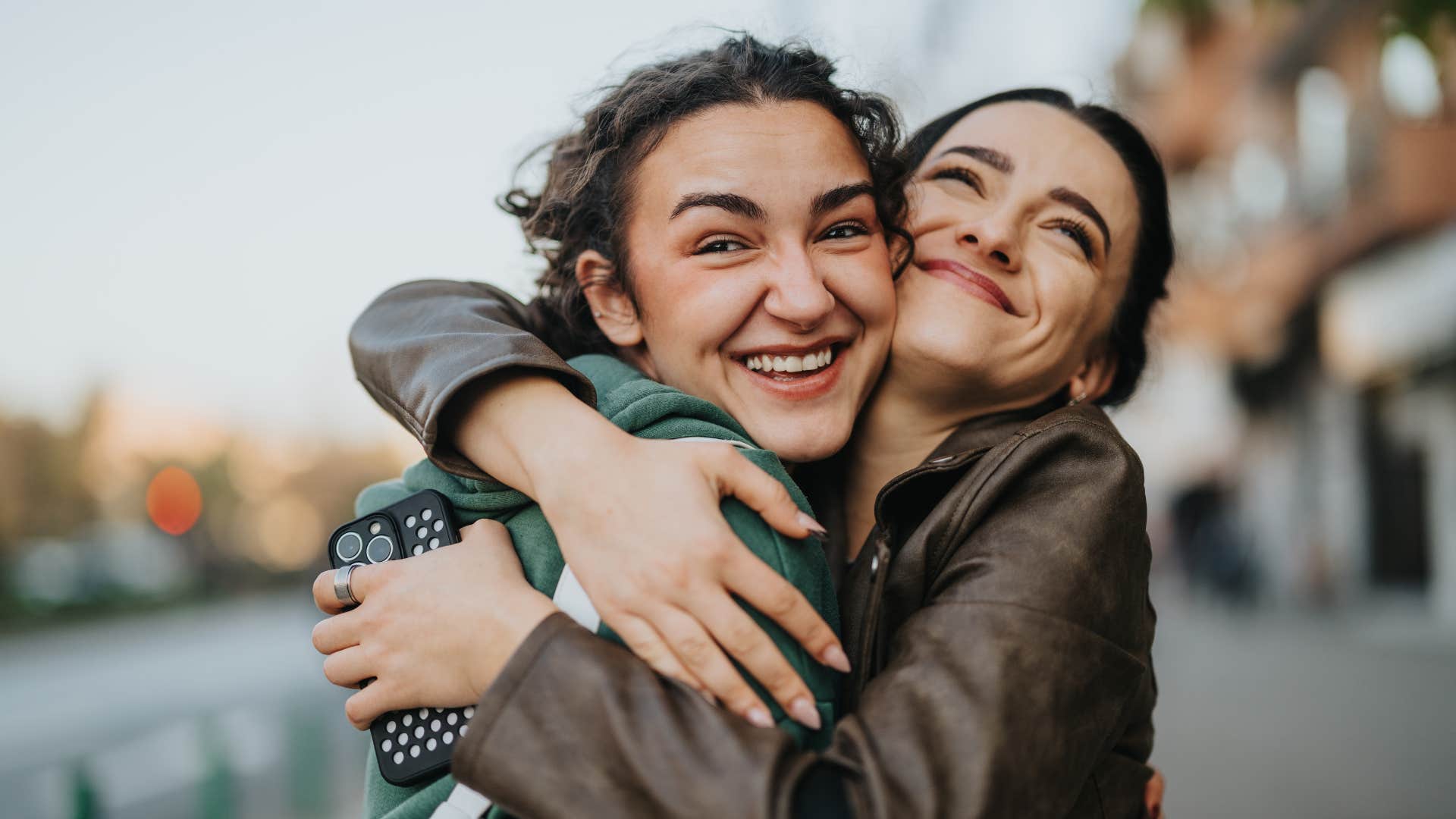 women hugging each other as they have a close friendship