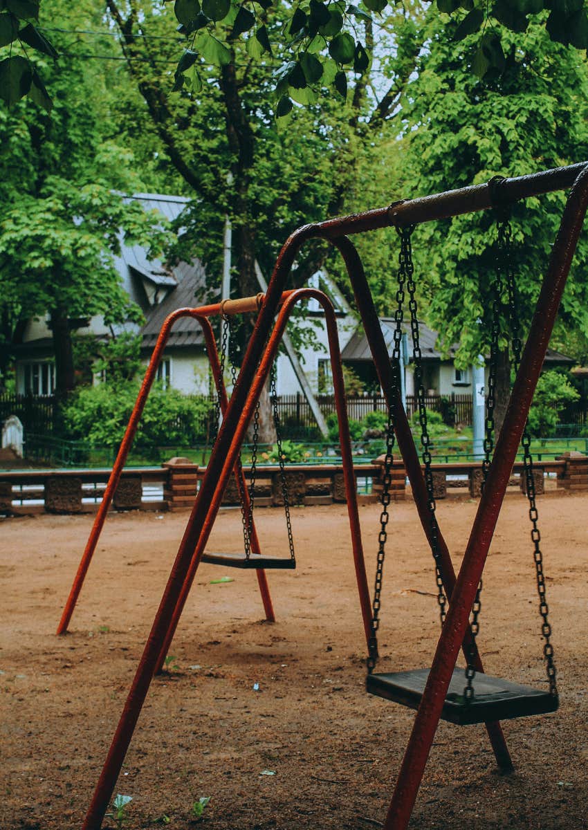 nostalgic empty childhood swing set