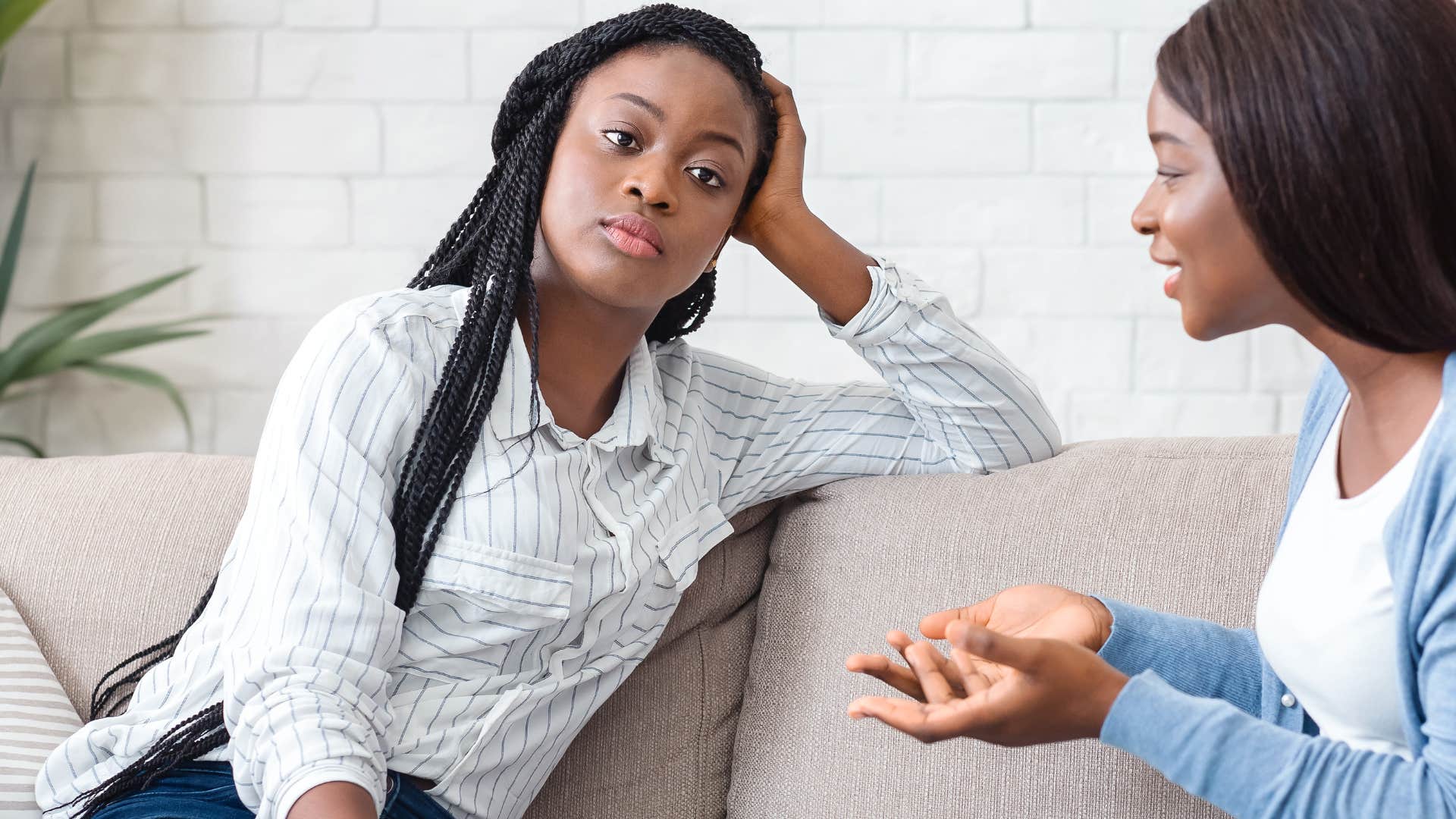woman sitting with a friend feeling drained by her