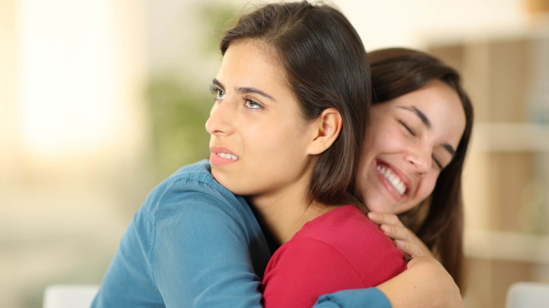 woman hugging friend about to shut down her excitement