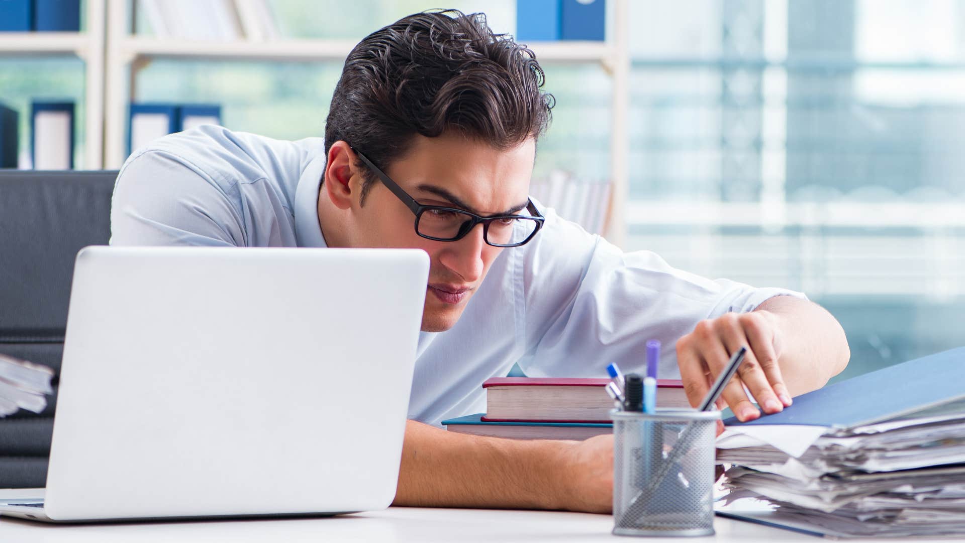 high iq man with a messy workspace at his office