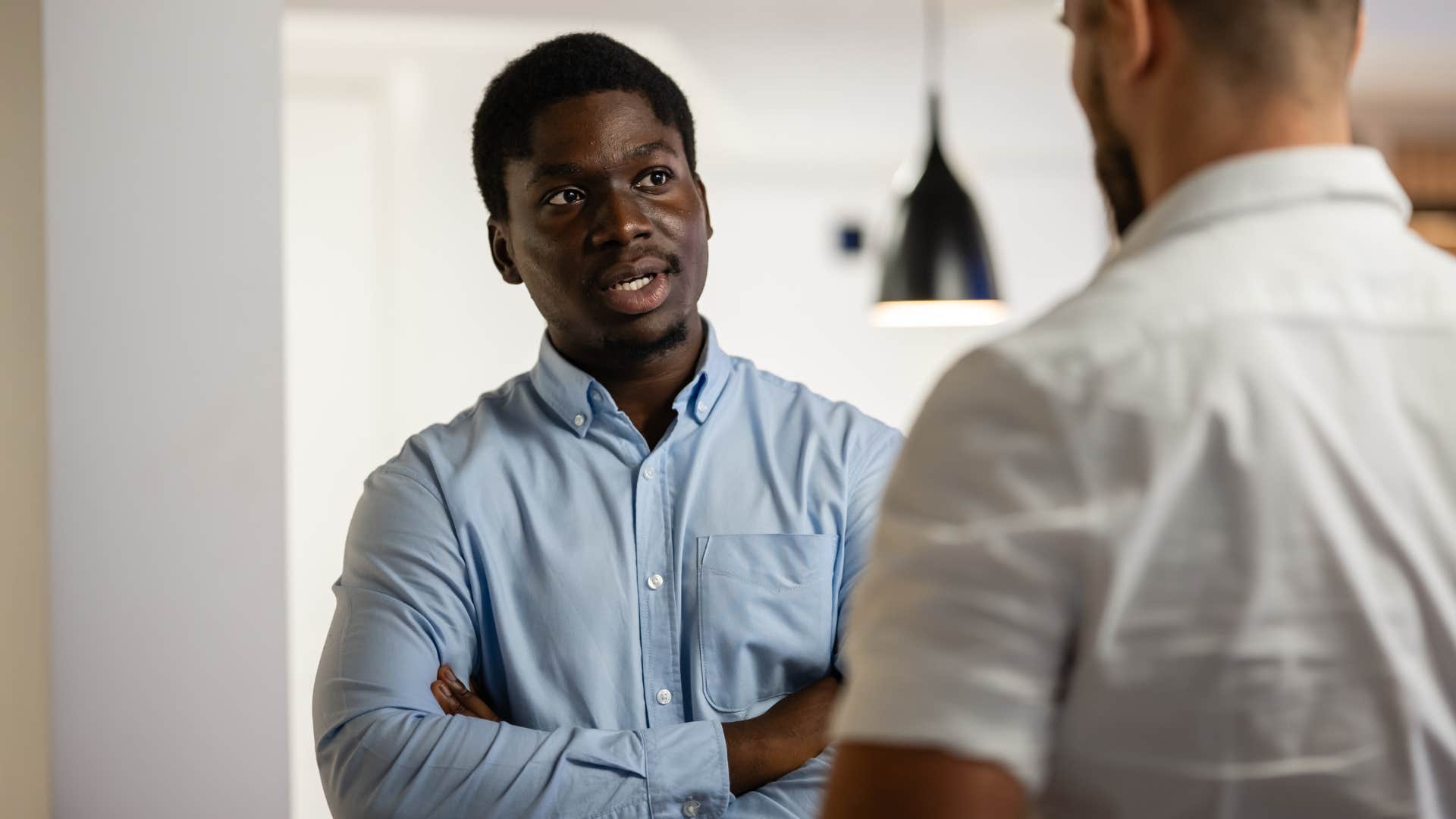 intelligent man leaning into debates and hard conversations at work