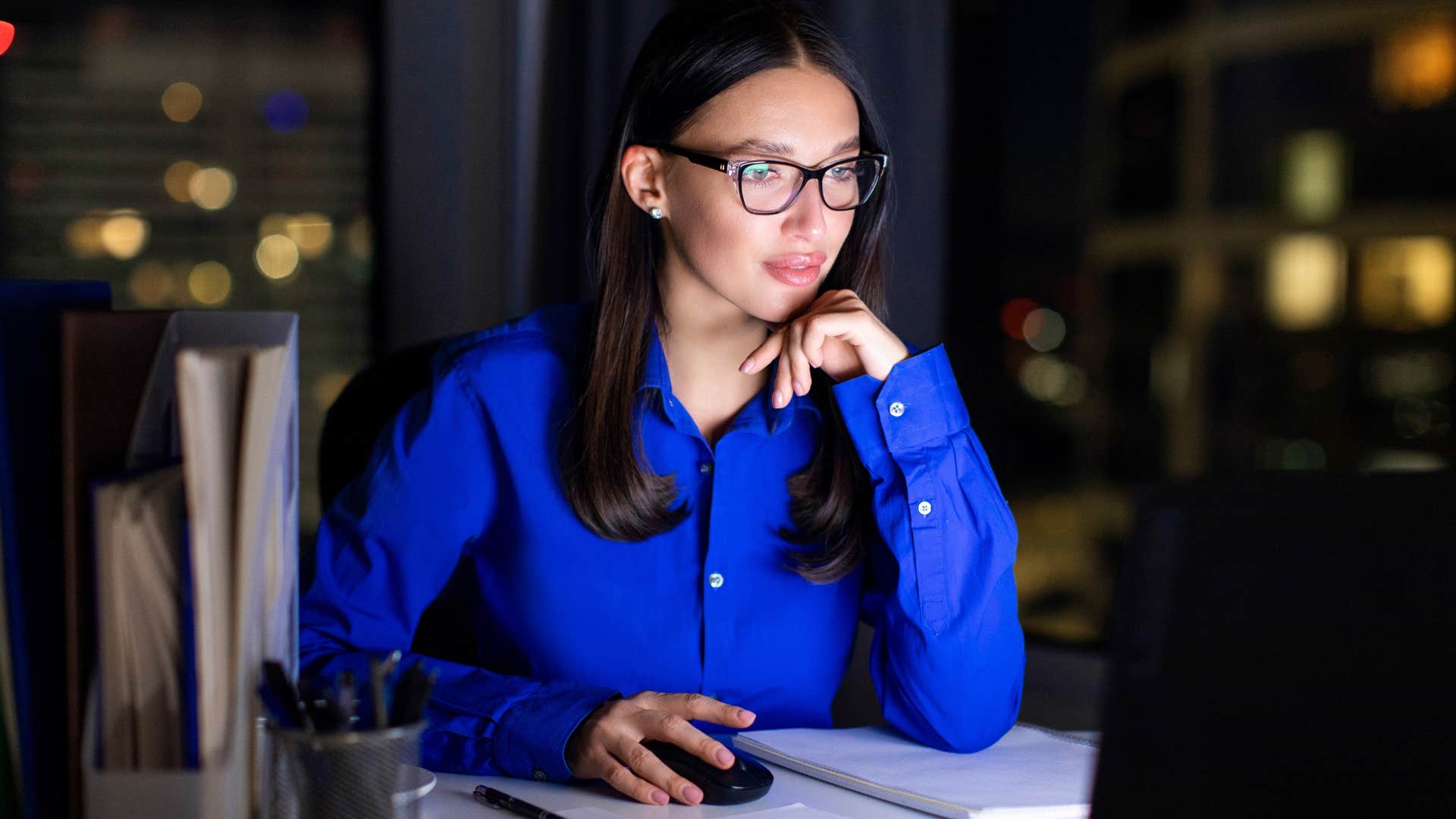 woman with a high iq who's a night owl working late in an office