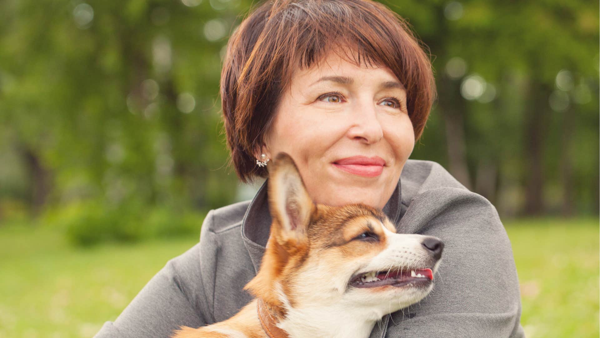 Woman enjoys keeping to herself with her pet dog outdoors