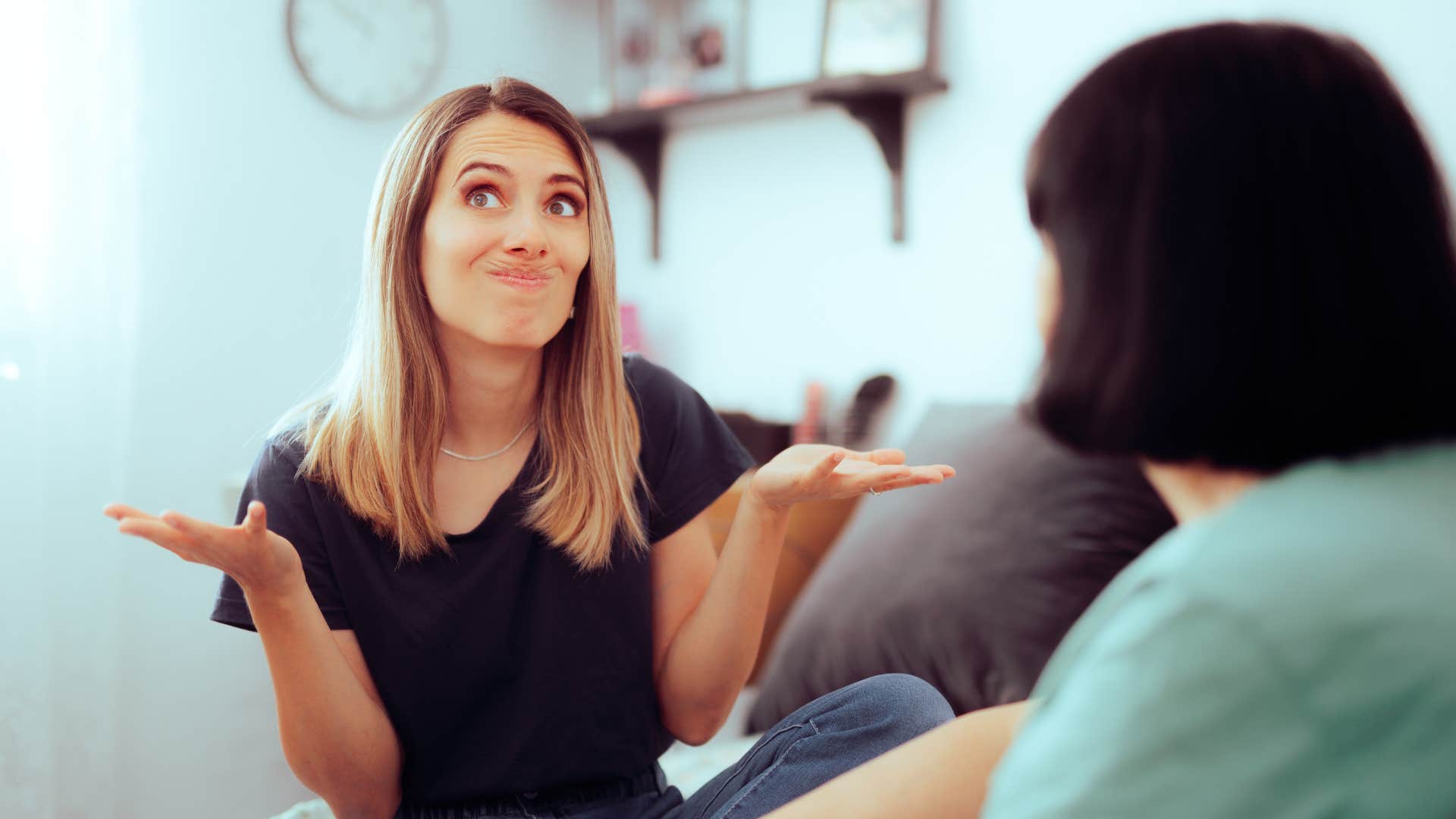 woman telling her partner she doesn't really know shrugging