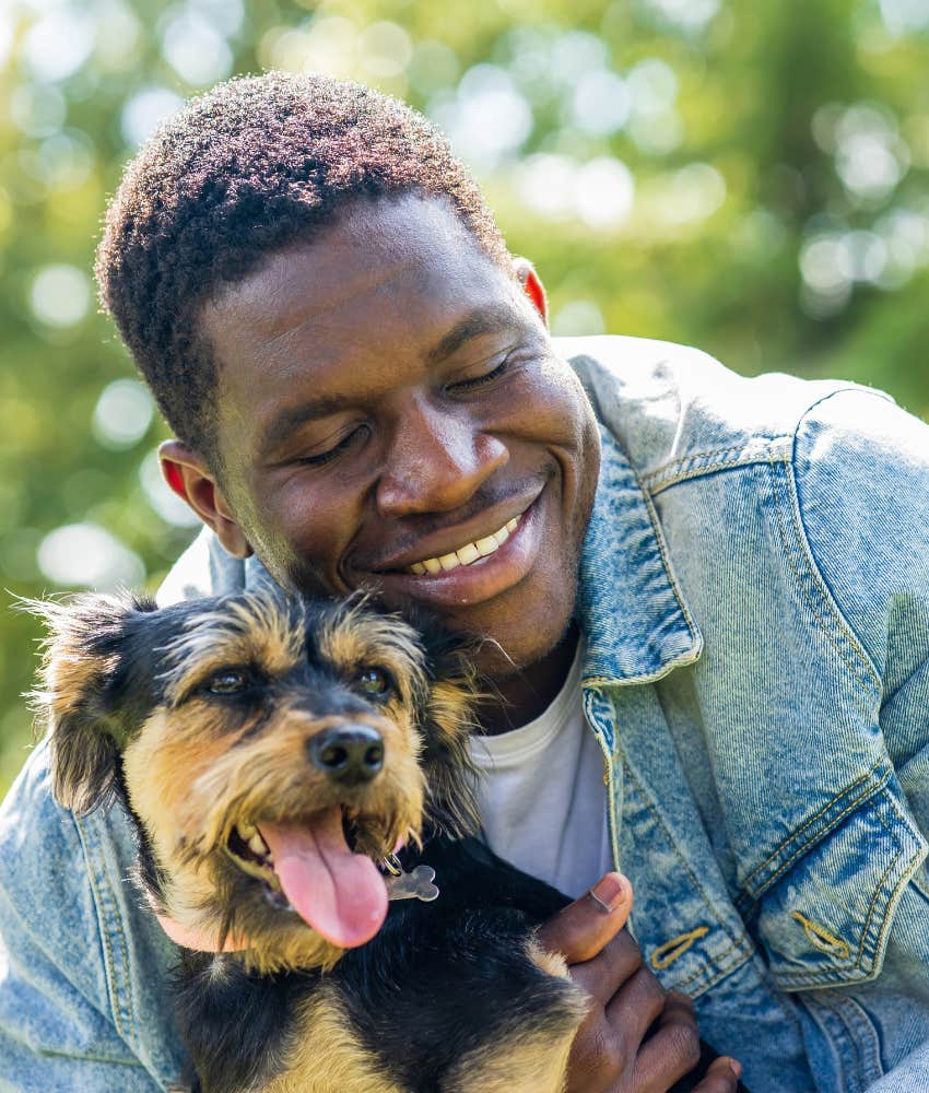loving person and happy dog showing trust