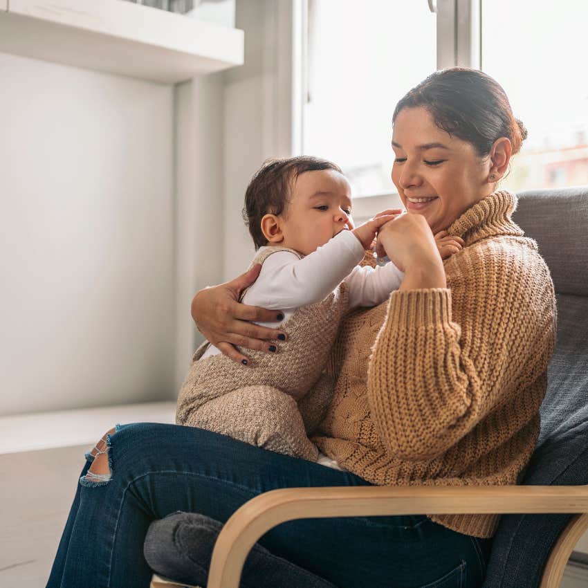 mom sitting with baby on chair