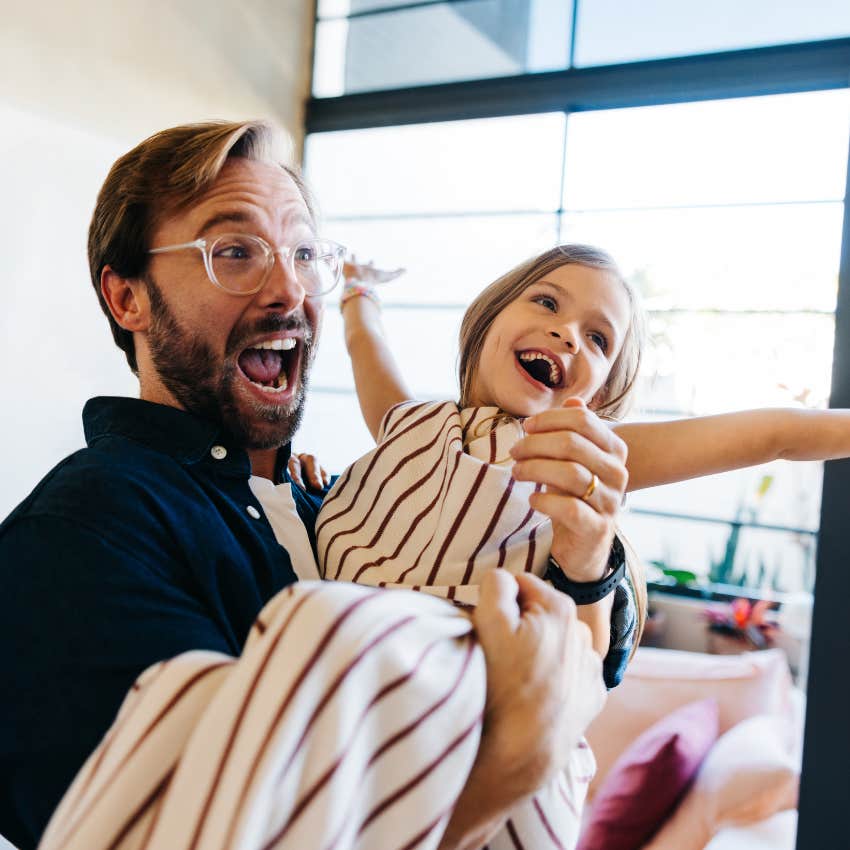 father lifting up daughter