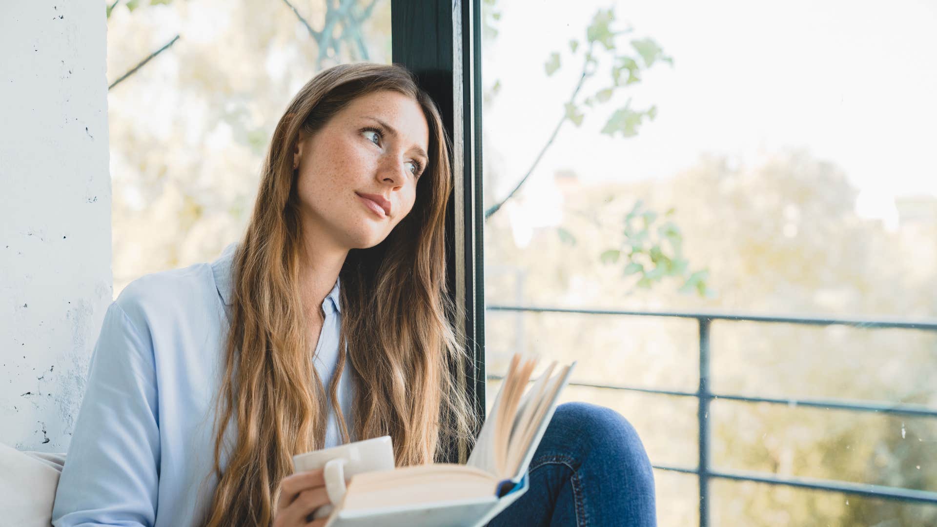 woman reading and thinking near window as she has good memory
