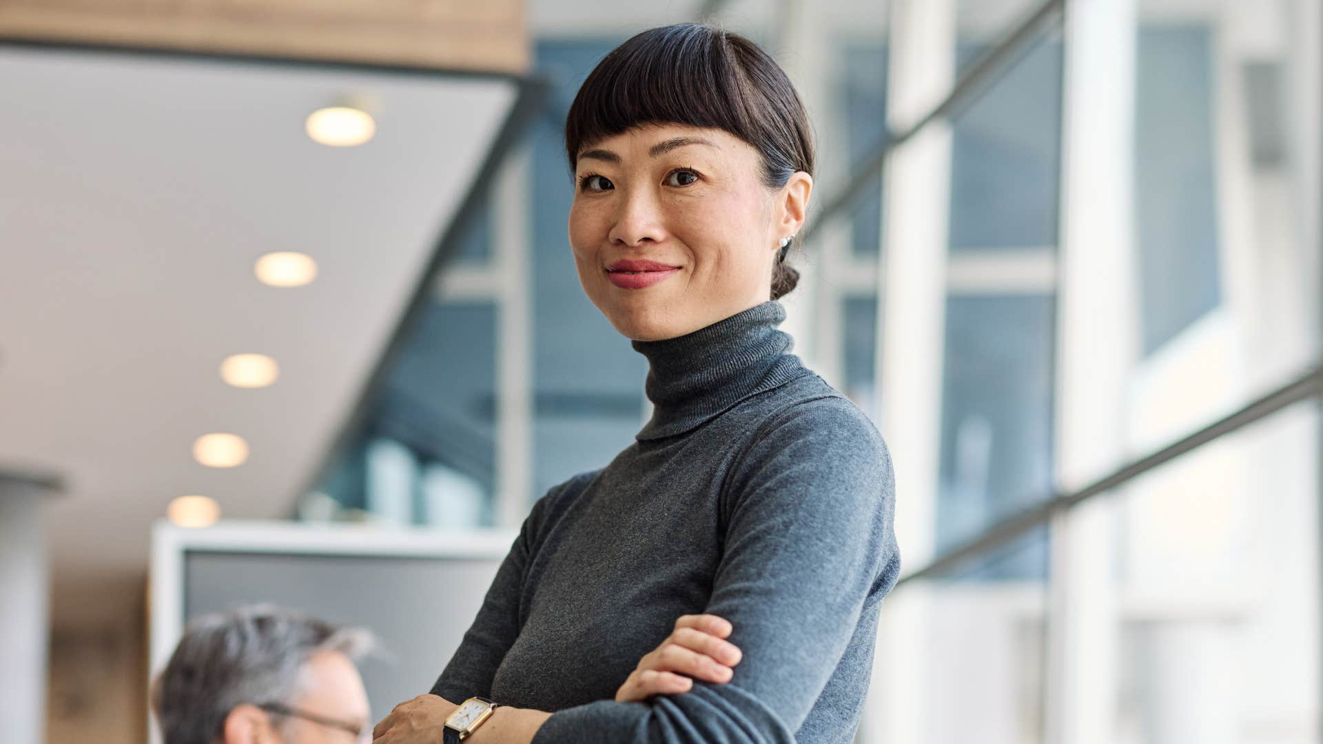 woman in gray shirt crossing arms as he's highly selective