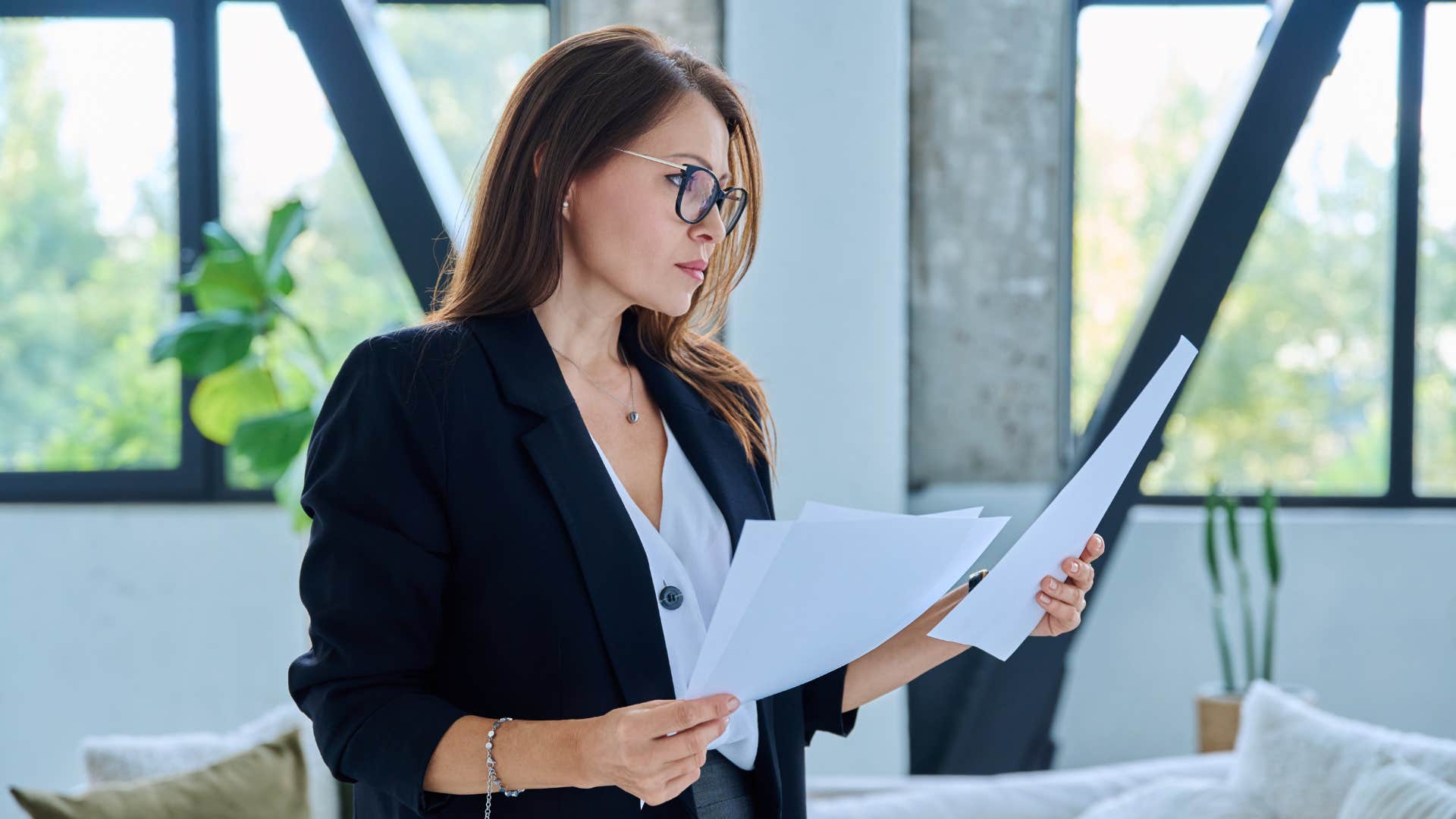 woman reading through papers as she's very consistent 