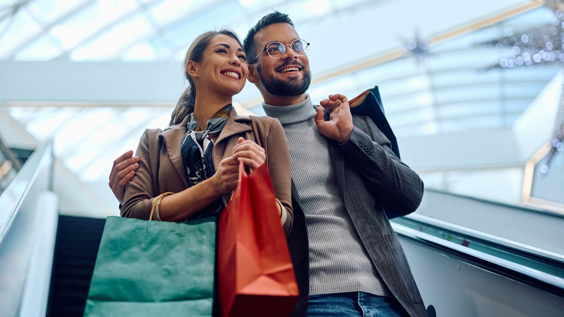 couple on escalator after purchasing fast fashion items