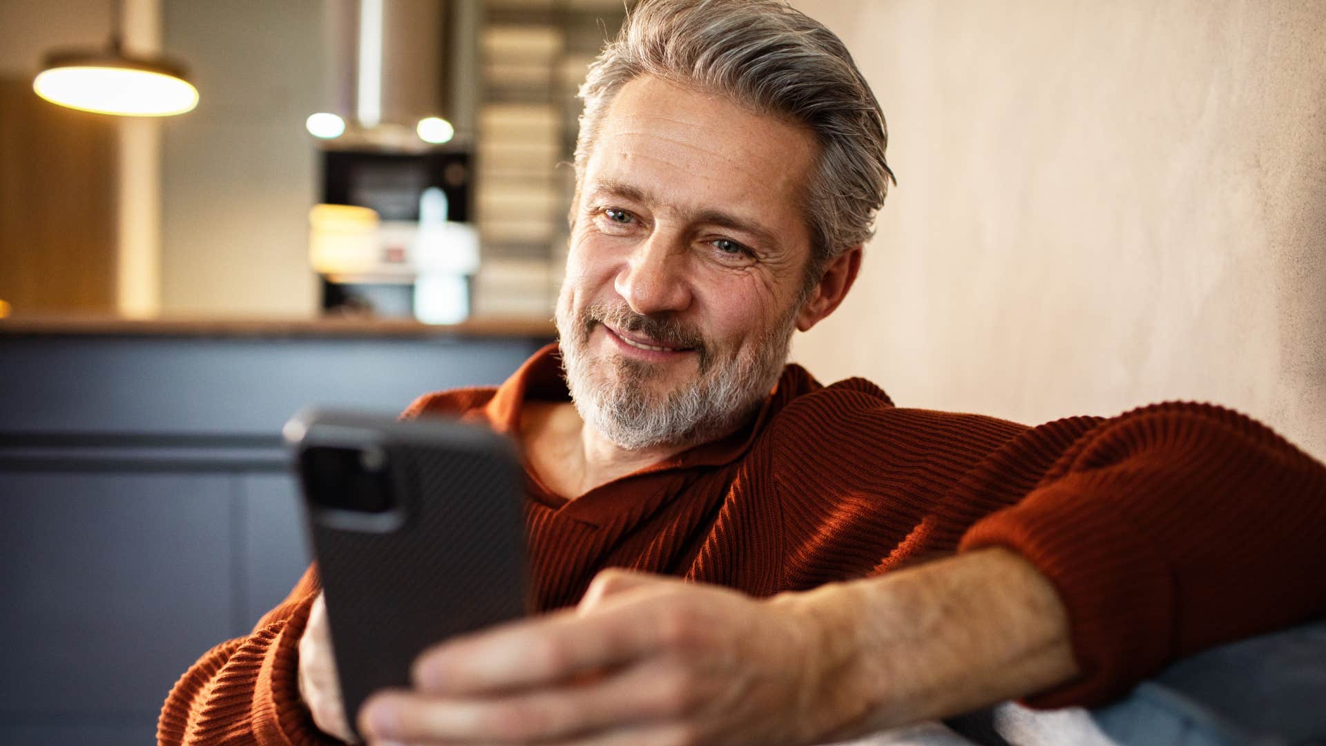 man being rude to people on dating apps looking at phone