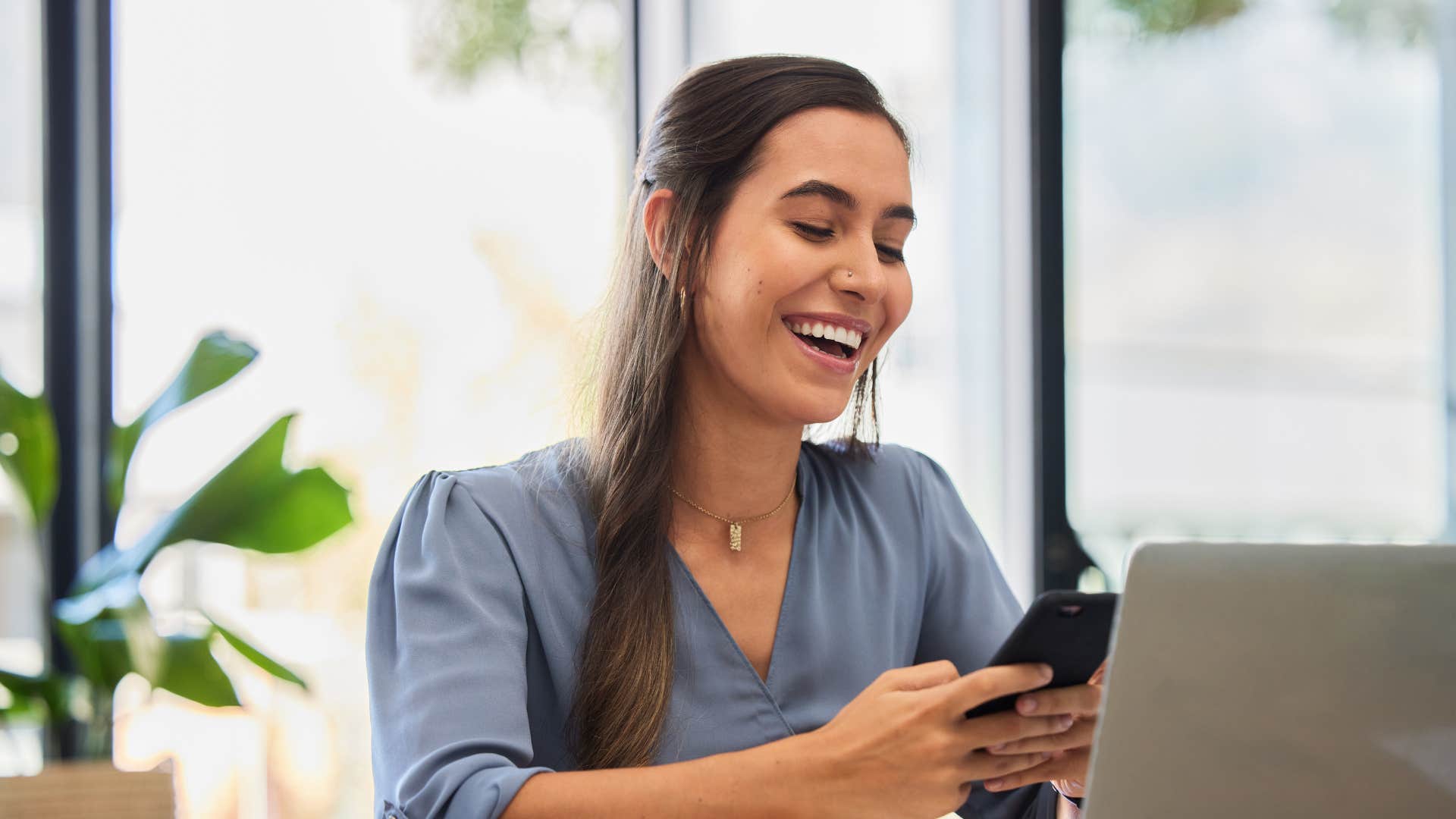 woman looking at phone for entertainment