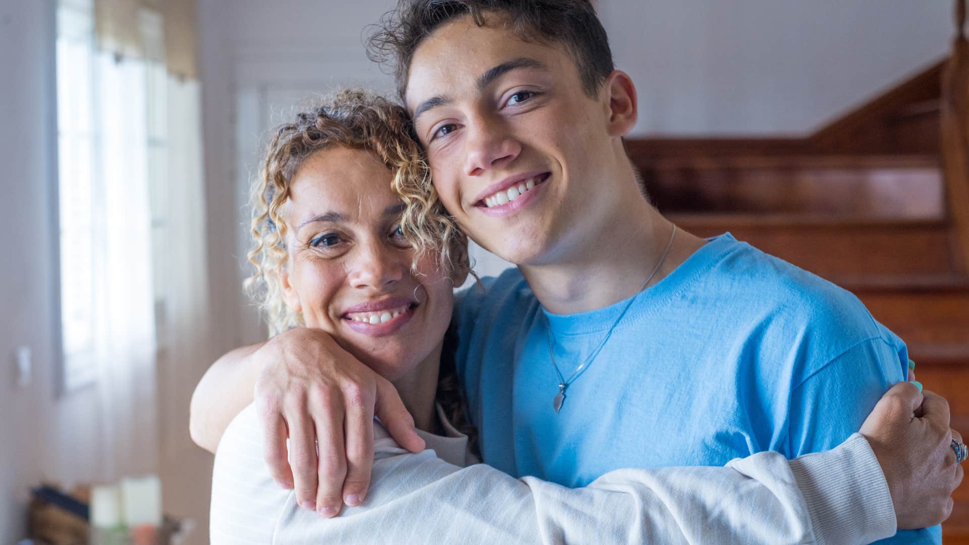 older woman without generational resentment hugging her son