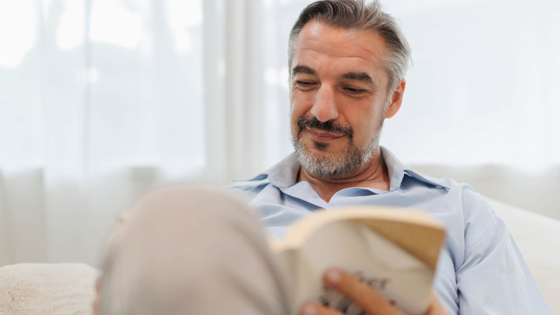man who was raised in the 60s and 70s avoiding social media and reading a book