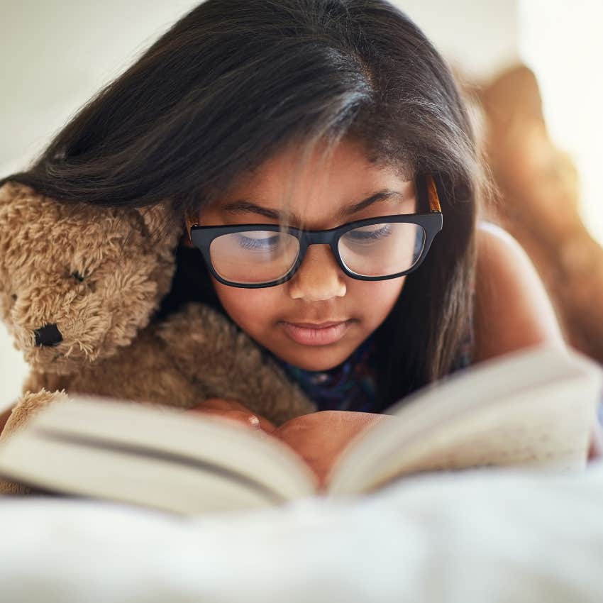 Little girl spending most of her time alone reading at home.