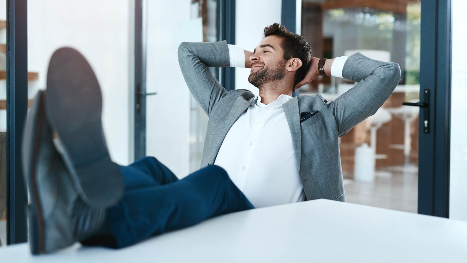 man relaxing at work feeling calm under pressure