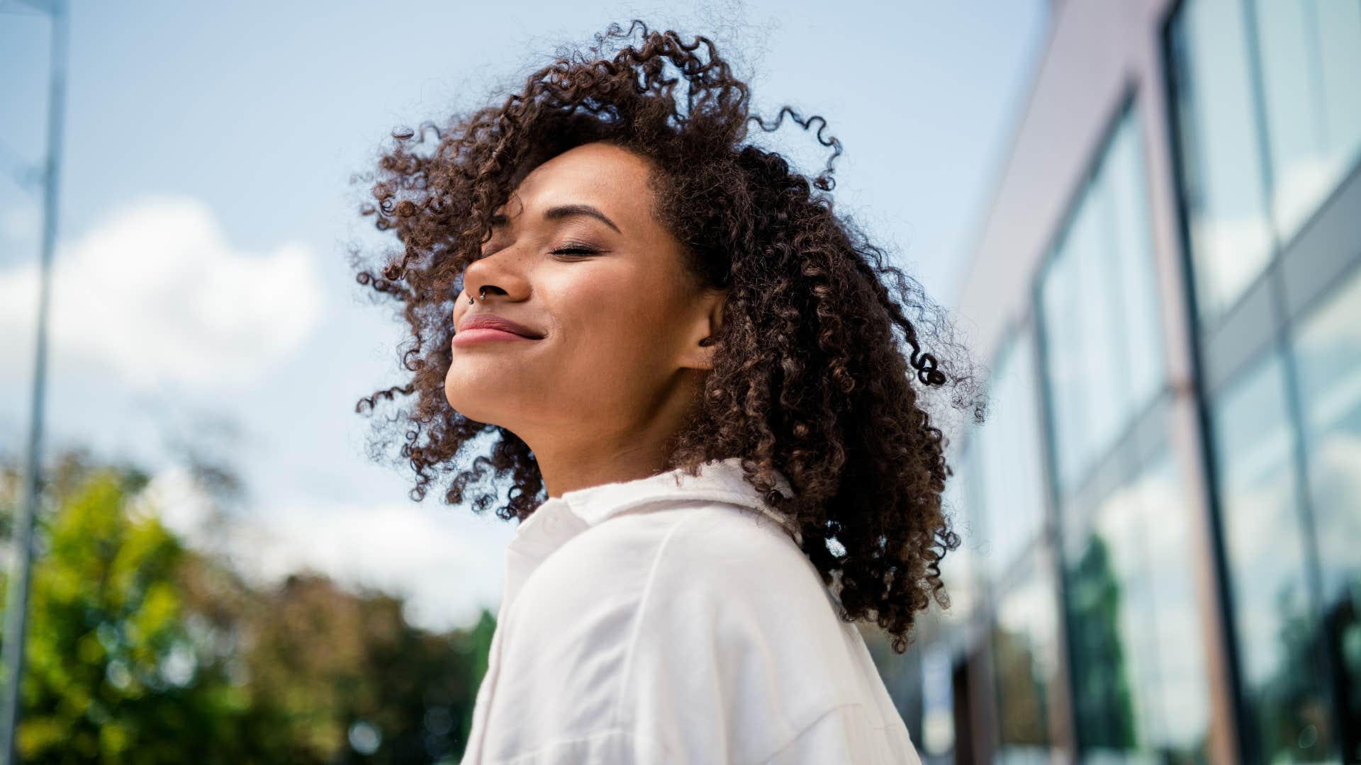 woman smiling confidently in the sun