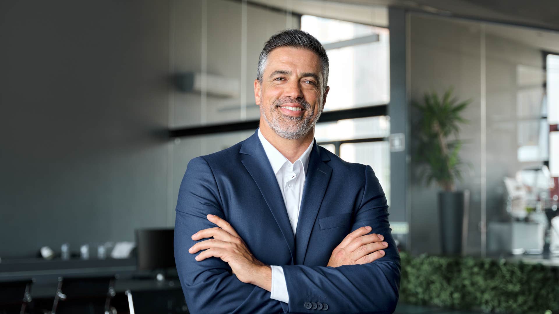 confident man in suit with arms crossed
