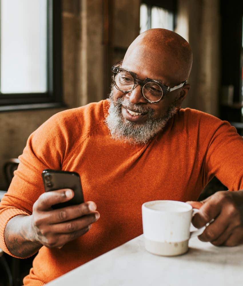 older person at cafe with cell phone showing technology to connect in real life