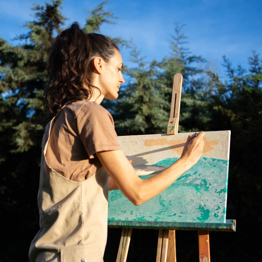 creative woman painting in nature sees faces in everyday objects