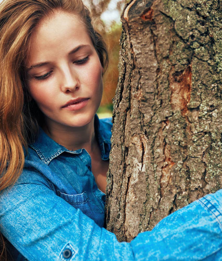 adaptable person hugs tress