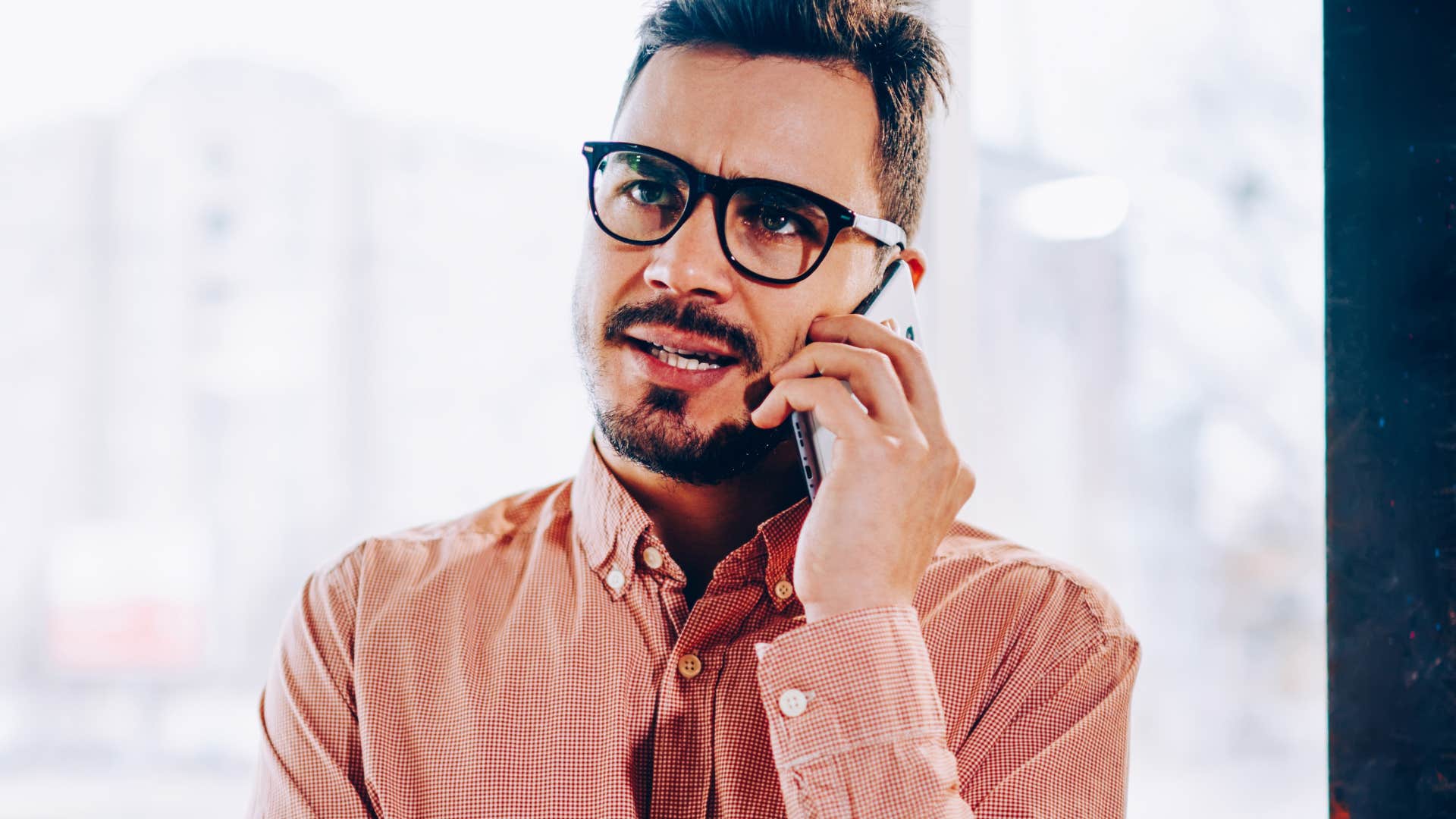 man with adhd traits on the phone getting irritable easily