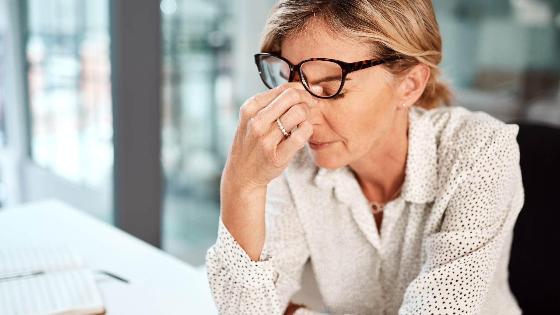 exhausted woman looking stressed at work