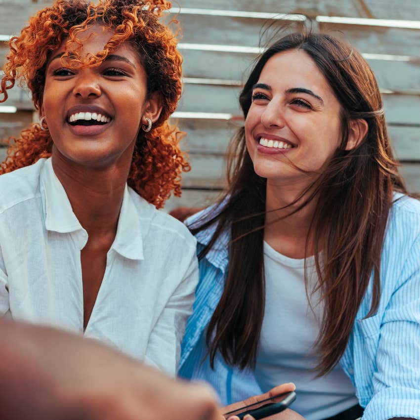 two women connecting with people easily and smiling