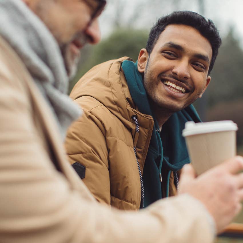 laughing man reading between the lines in a conversation with a friend