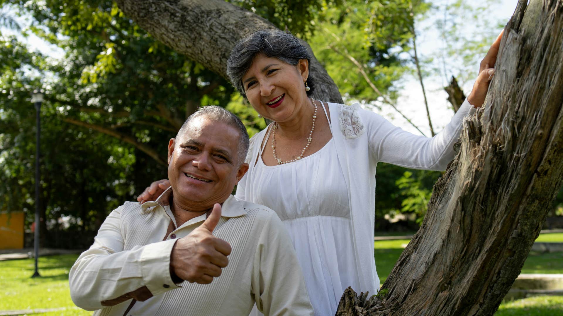 happy older couple give thumbs up showing simple change of focus