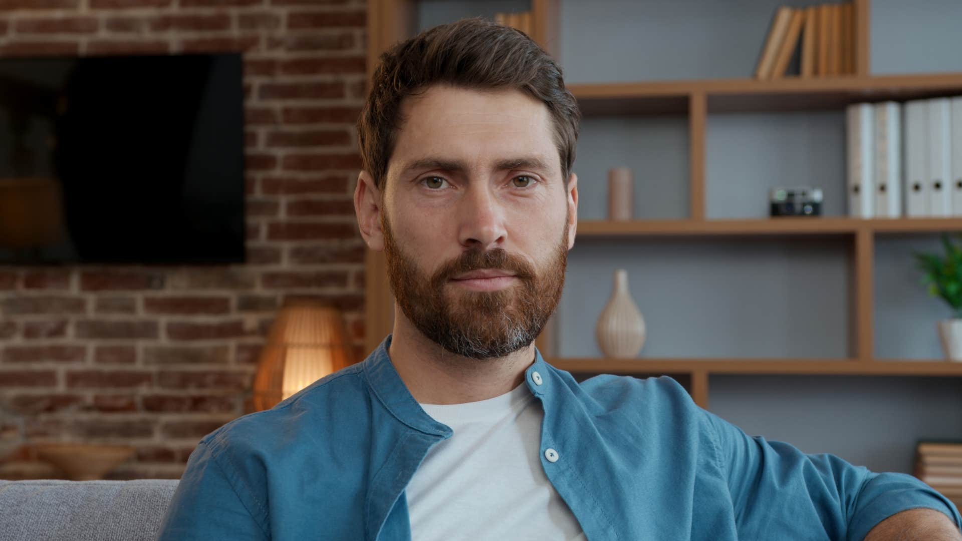 serious man who is hyper-aware of his limits sitting at home