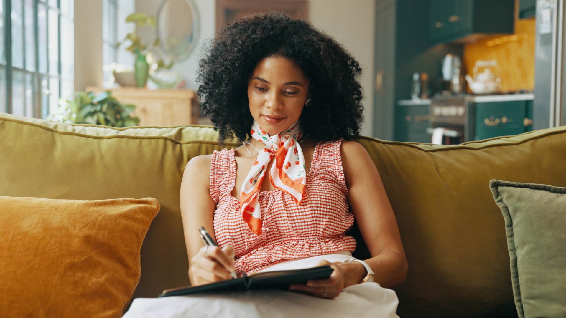 emotionally woman writing in her journal 
