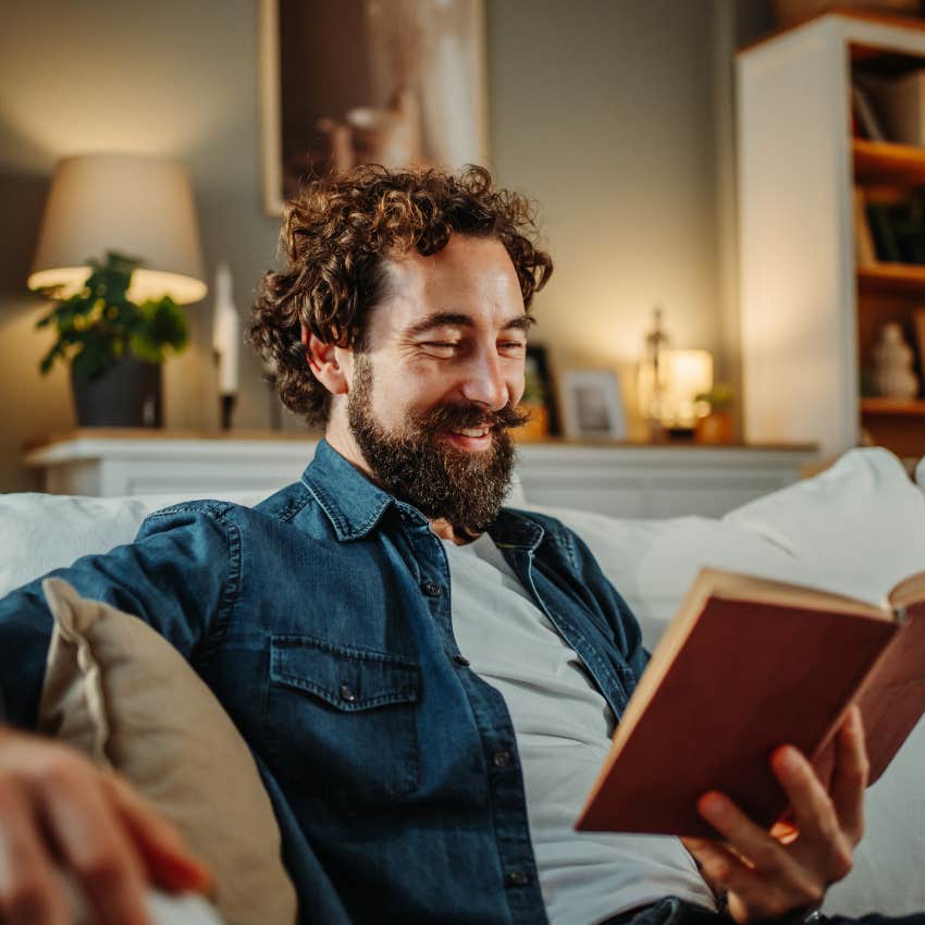 compassionate man comfortable with solitude reading at home