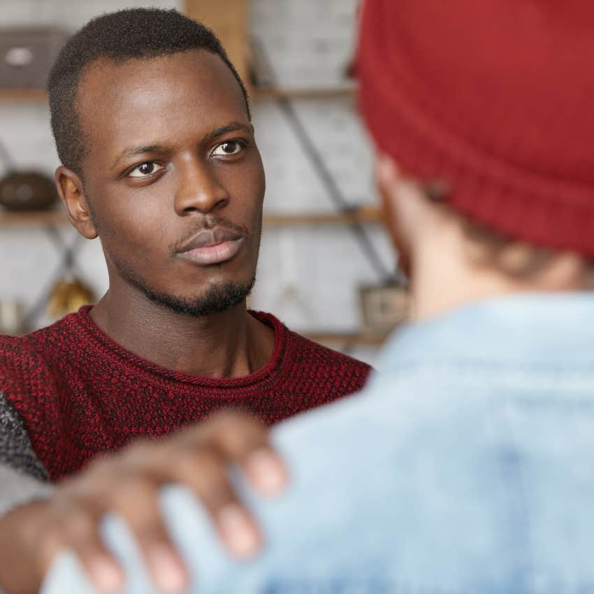 compassionate man comforting friend