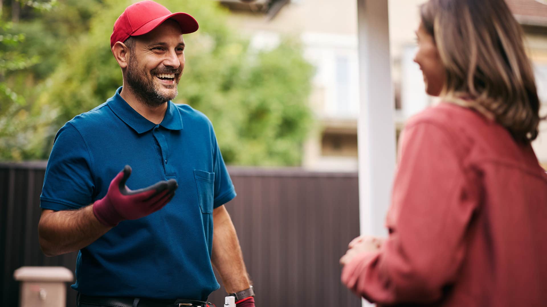 Socially conscious and aware woman talking to a landscaper in her yard.