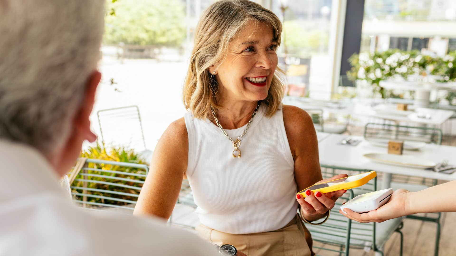 Woman who understands the value of money paying at a restaurant.