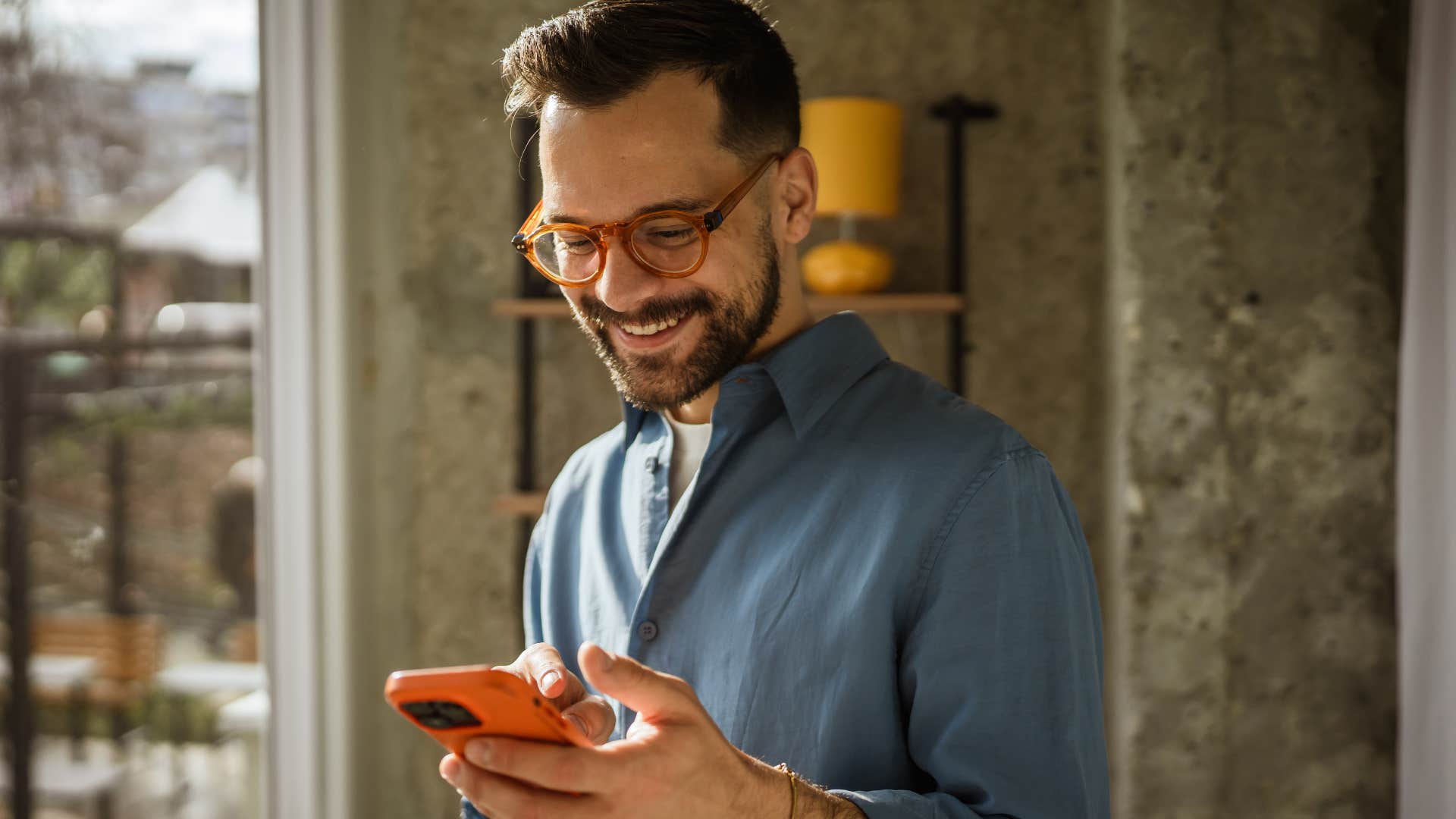 man who accepts himself for who he is looking at his phone