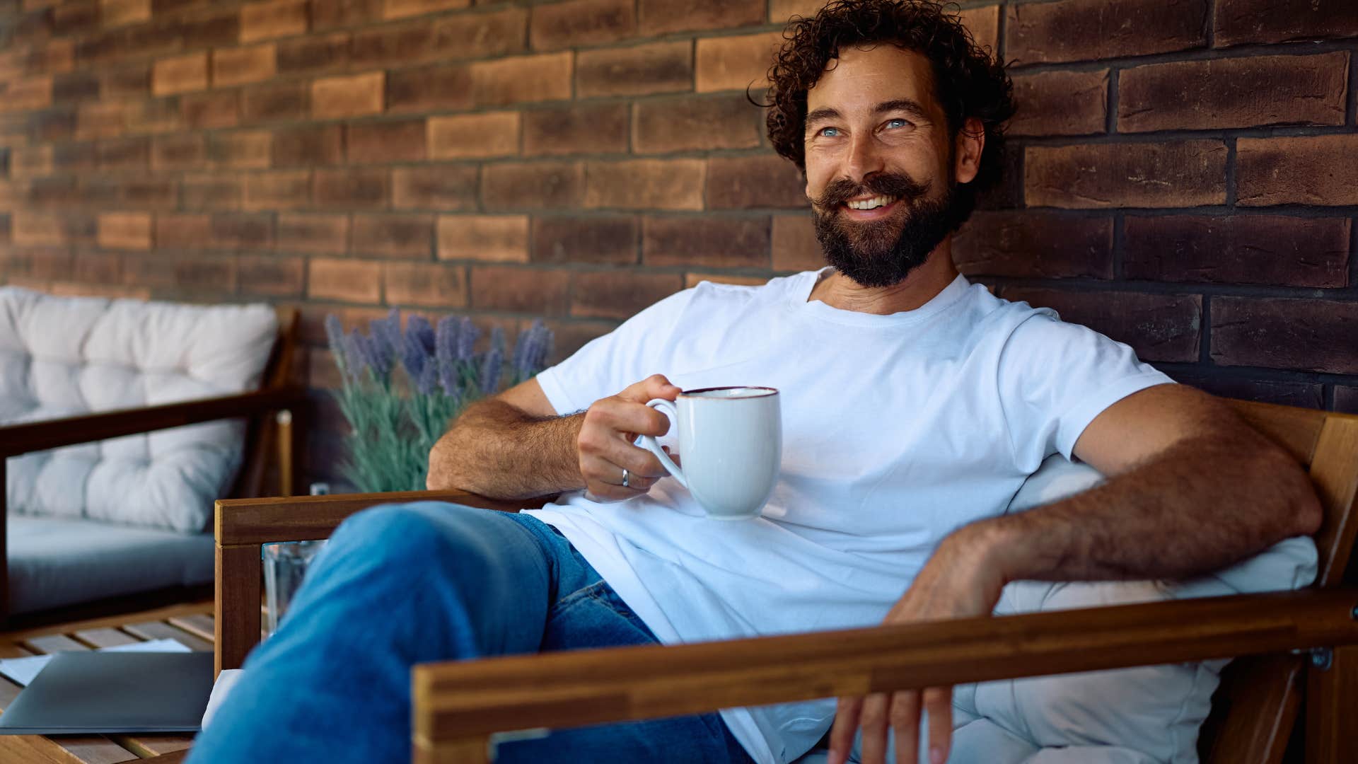 happy man who enjoys his own company drinking coffee