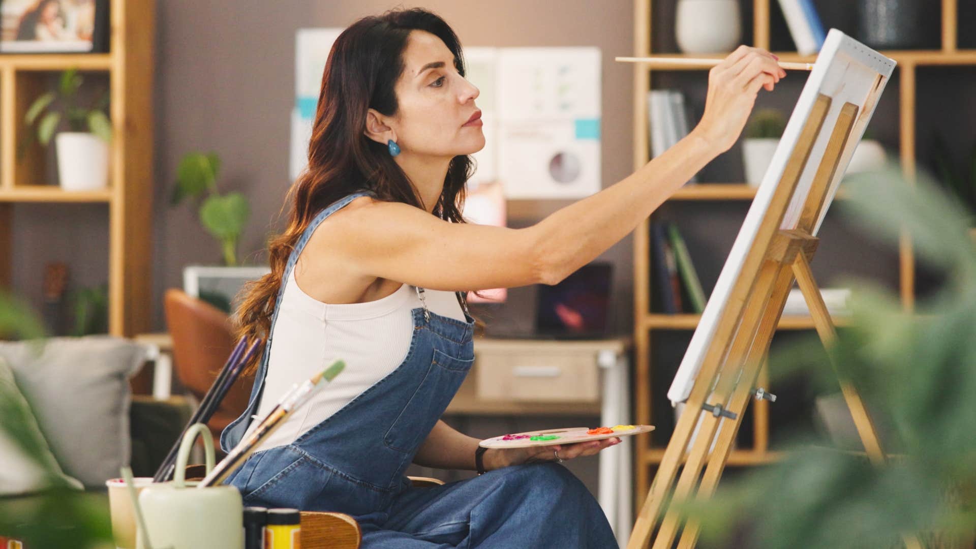 woman who's more creative on her own painting at home