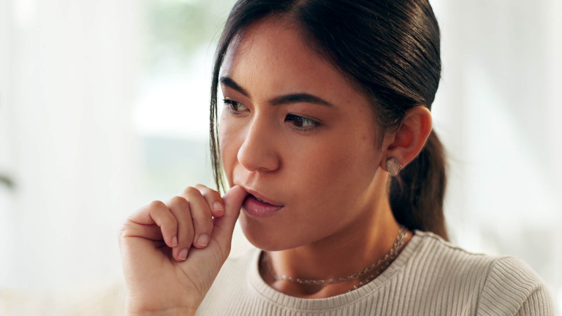 Woman with too much on her plate sitting at home.