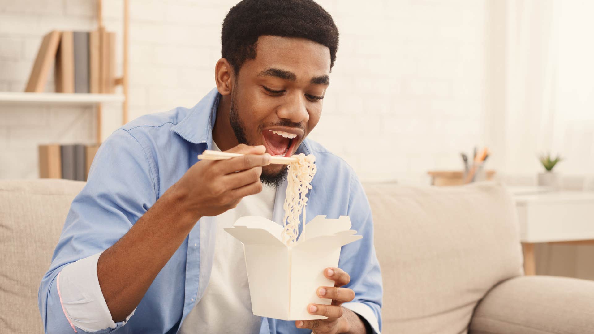 Man who's overly reliant on convenience eating at home.