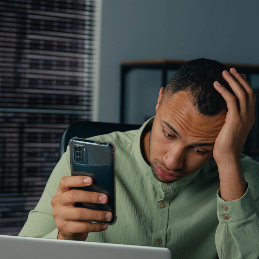 stressed man holding phone