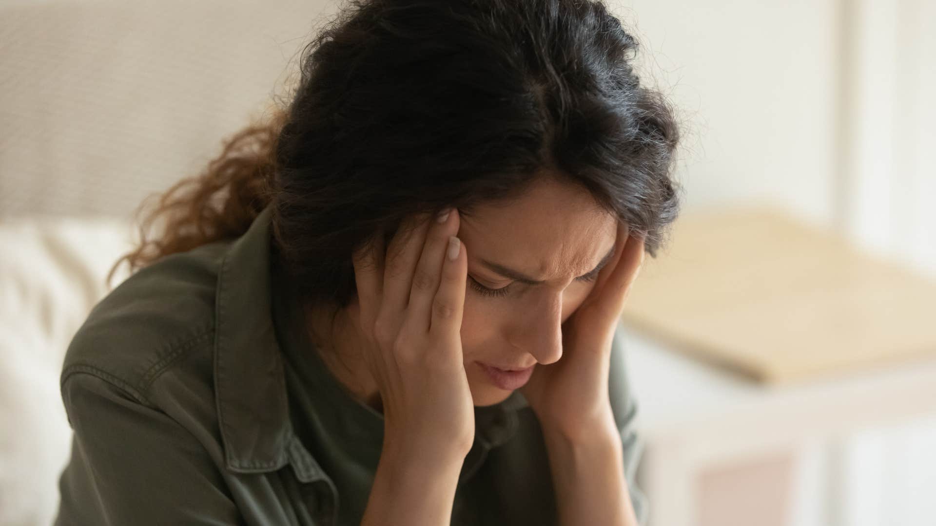 antsy and restless woman sitting alone at home stressed