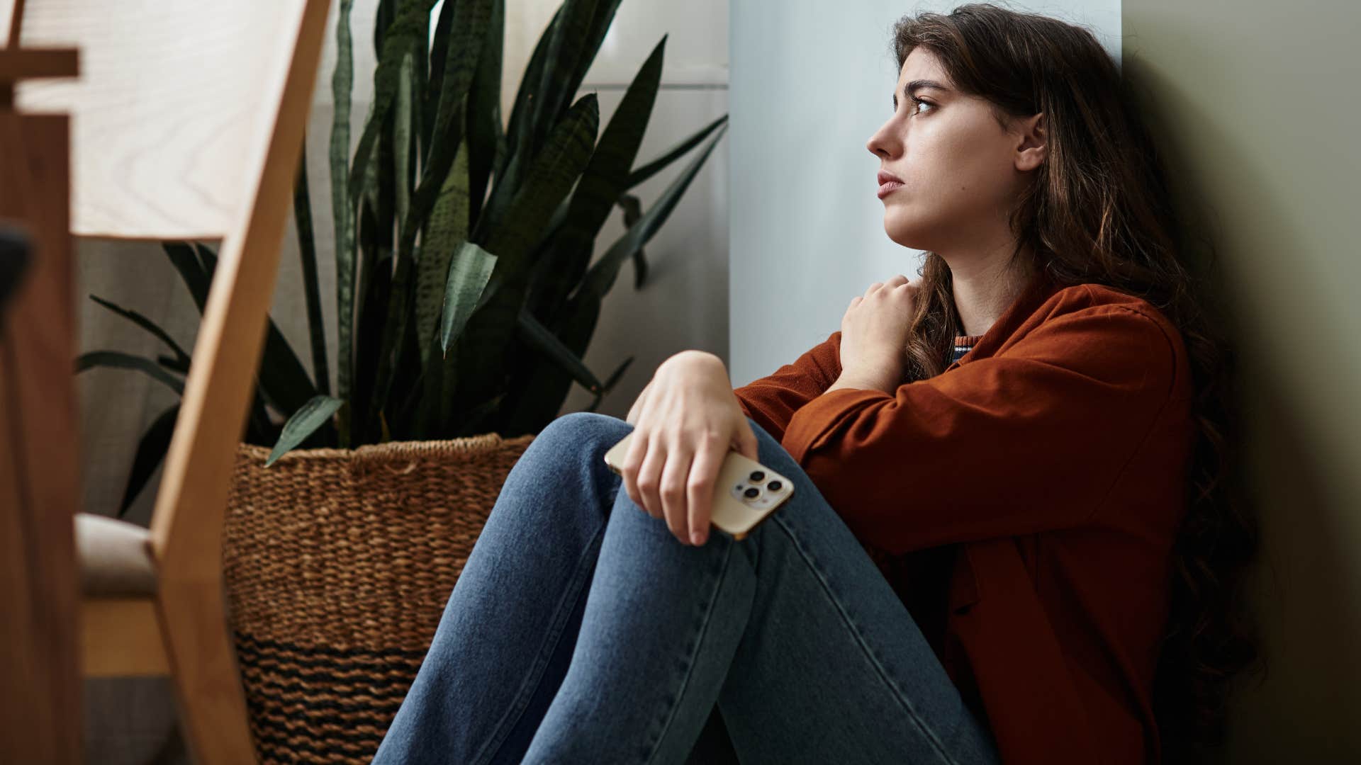 woman who feels and processes things in unique ways sitting on the floor at home