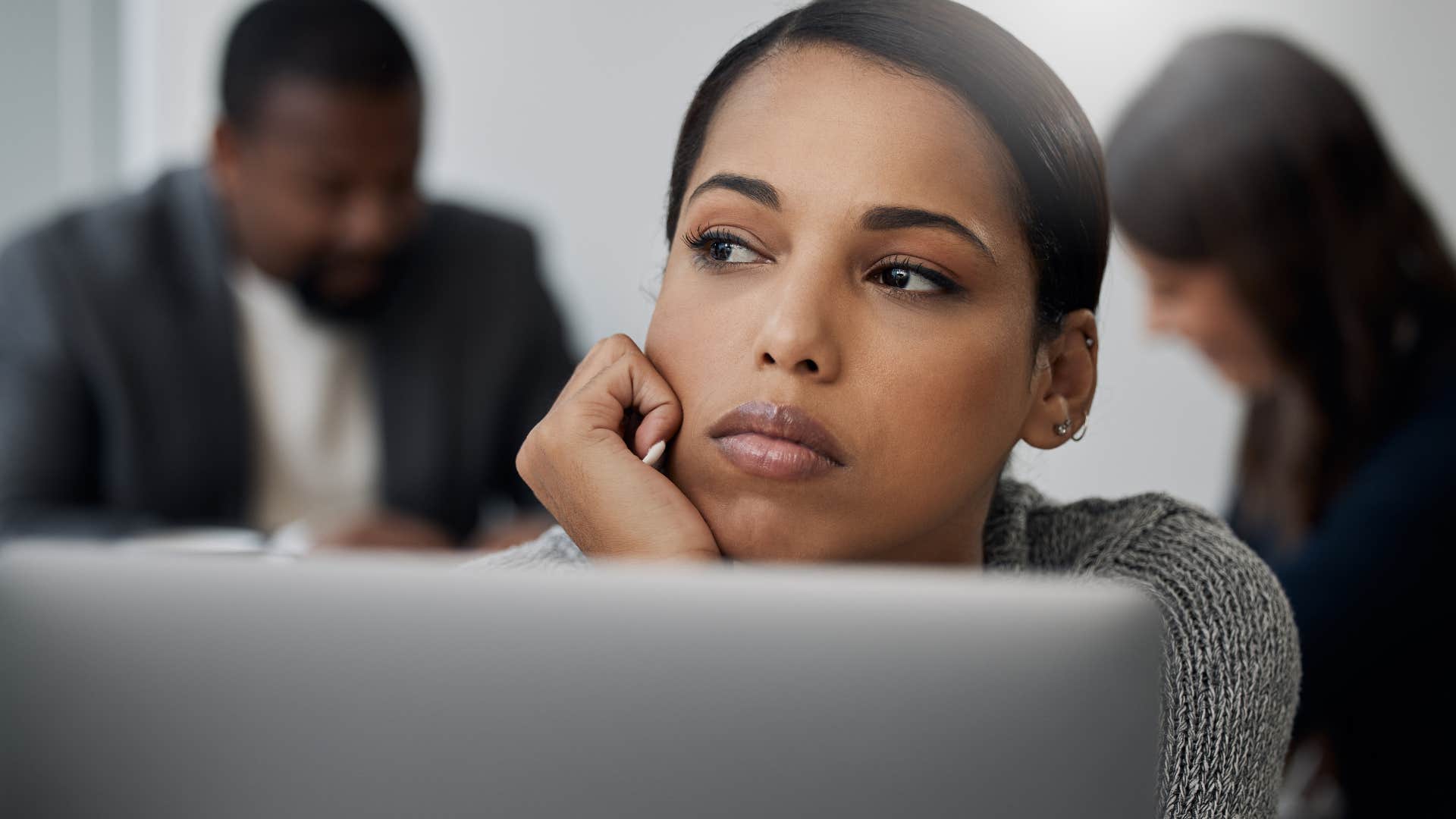 woman who's an imaginative daydreamer zoning out at work